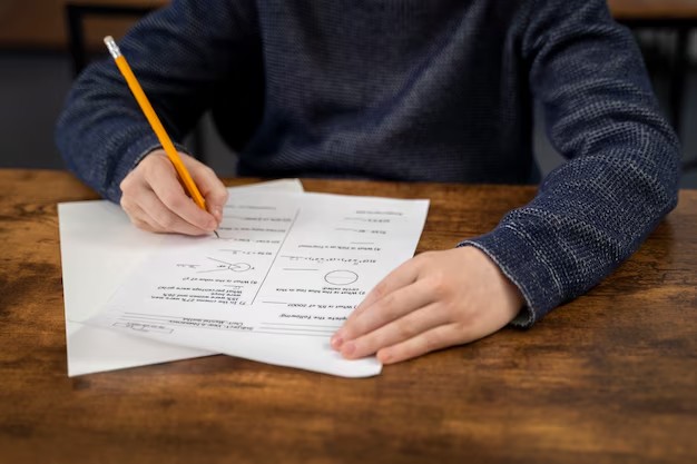 GMAT exam preparation with pencil and paper explaining the average NUS MBA GMAT score